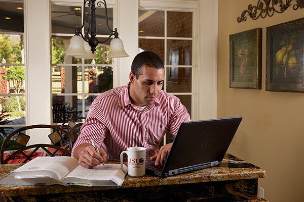 man working at home at computer